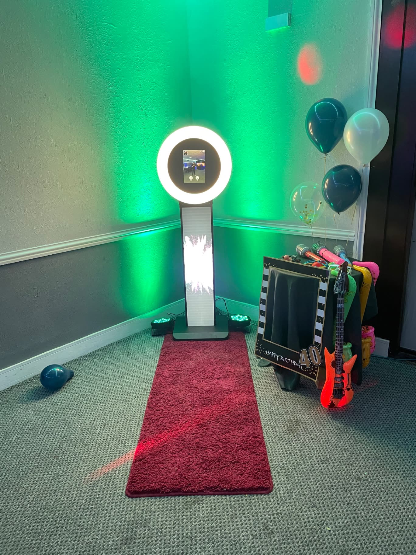 Photo booth setup with red carpet at an event