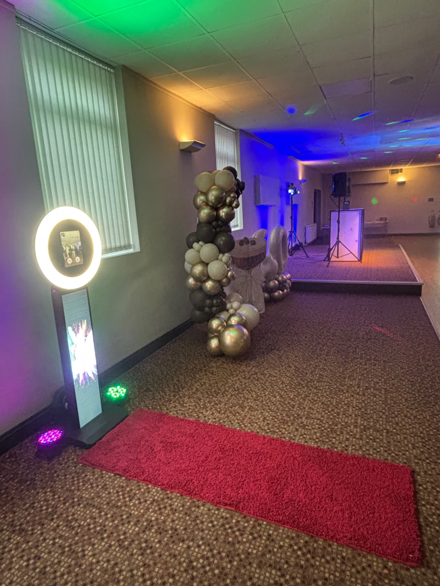 Photo booth with balloon decor and red carpet